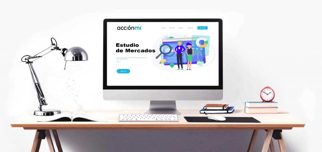 Computer screen on a desktop showing AcciónMK's market research page.